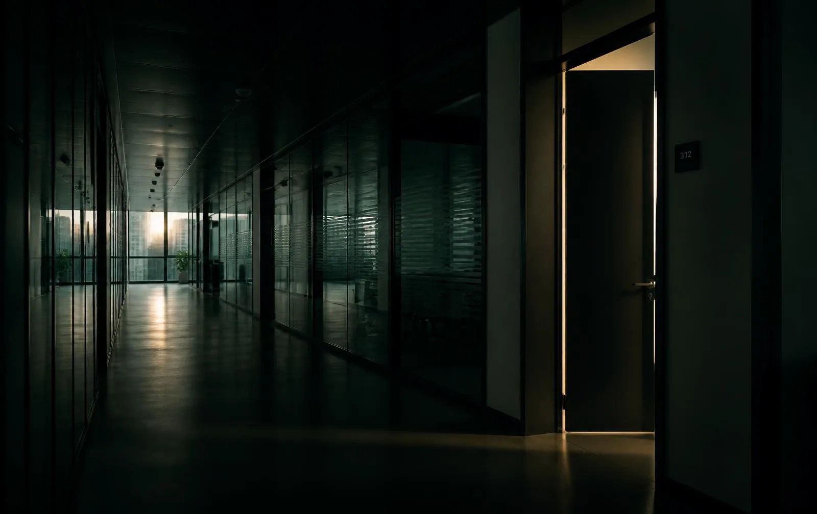 A quiet corridor with one door open, light spilling into the hallway